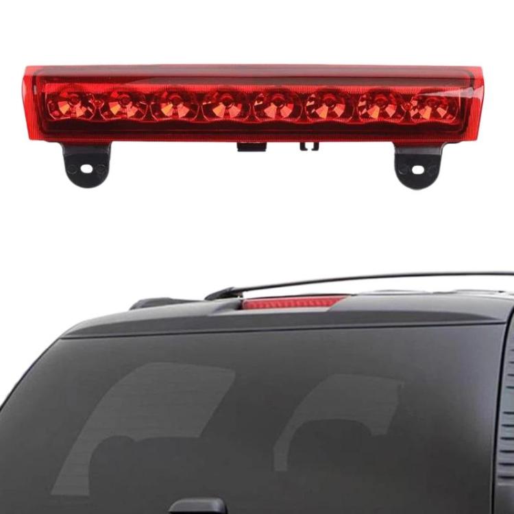 Rear tail light assembly with red lens mounted on vehicle rear