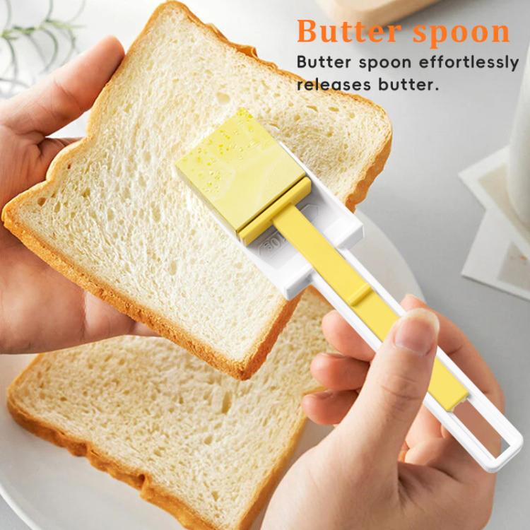 Butter cutter spoon spreading butter on sliced bread, yellow and white handle