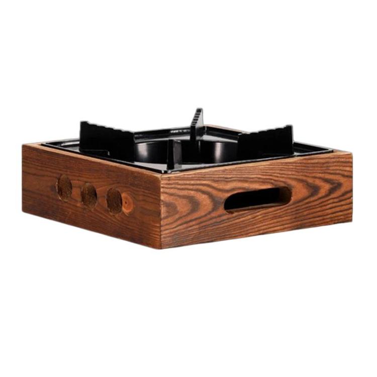 Square three-hole alcohol stove base with dark metal burner in wood frame