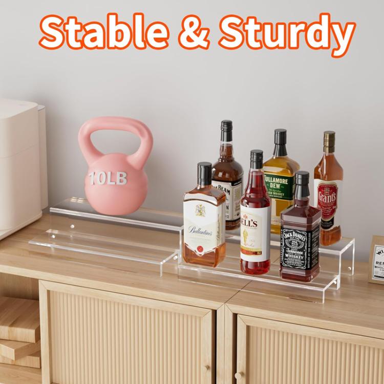 Clear acrylic 2-tier bottle rack on countertop with several bottles