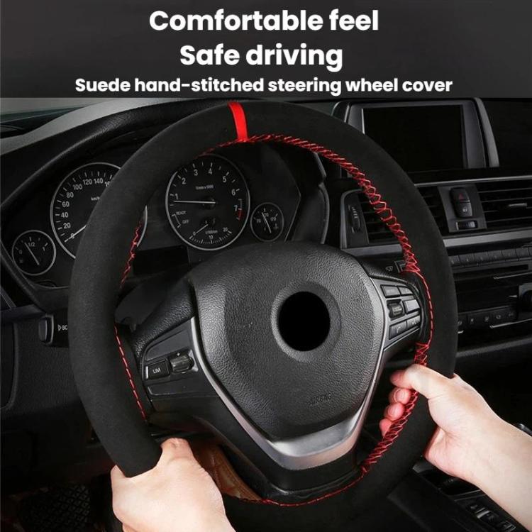 Suede steering wheel cover on car wheel, black with red stitched trim