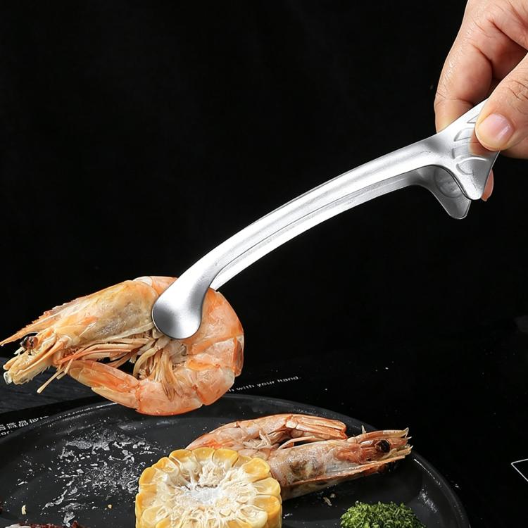 Stainless steel food tongs gripping shrimp on a round tray