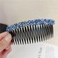 Sparkly hair clip comb with blue rhinestone top and black comb teeth