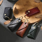 Set of leather key pouches in green, black, brown, and red with metal keyrings