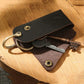 Leather key pouch holding keys with metal keyring and snap button closure
