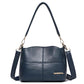 Dark blue leather shoulder bag with top handles and crossbody strap, front logo patch