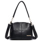 Black leather shoulder bag with top handles and crossbody strap, front logo patch