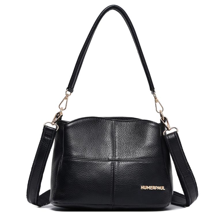 Black leather shoulder bag with top handles and crossbody strap, front logo patch