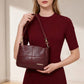 Burgundy leather crossbody shoulder bag with chain straps and front logo patch