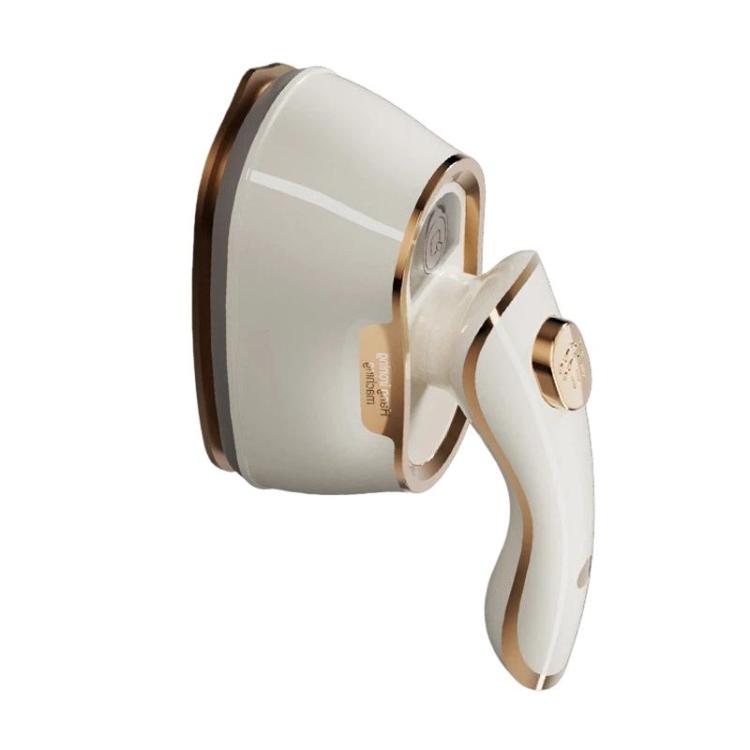 Side view of portable handheld steam iron in white with gold trim and nozzle