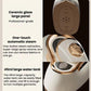 White handheld steam iron with perforated plate and control buttons