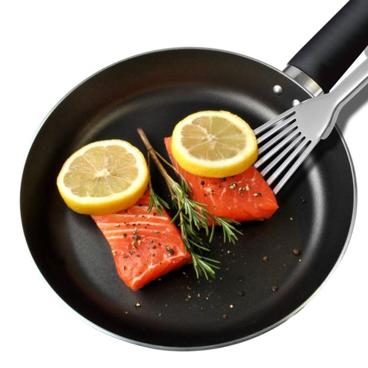 Stainless steel slotted fish spatula with angled fork head over a skillet