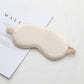 Beige satin sleep eye mask with elastic strap, smooth double-sided fabric.
