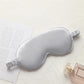 Silver gray satin sleep eye mask with elastic strap, smooth double-sided fabric.