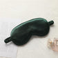 Dark green satin sleep mask with elastic strap, double-sided light-blocking design.