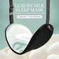 Black silk sleep mask with adjustable latex strap and buckle, curved eye shape