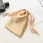 Champagne satin drawstring pouch for small jewelry, gathered top with ribbon ties.