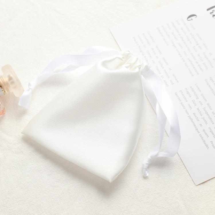 White satin drawstring pouch for small jewelry, gathered top with ribbon ties.