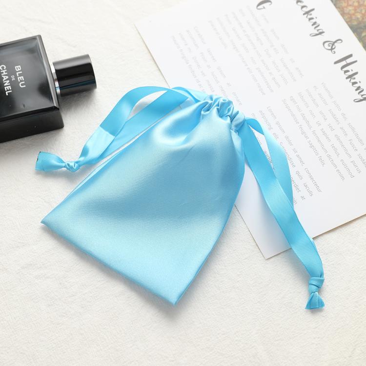 Sky blue satin drawstring pouch for small jewelry, gathered top with ribbon ties.