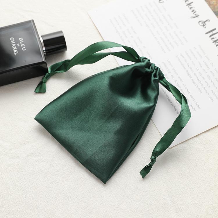 Small satin drawstring jewelry pouch, dark green with tied handles