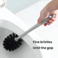 Toilet brush with gray handle and black bristle head used inside a toilet bowl