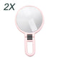 2X magnifying makeup mirror with round glass and pink folding handle