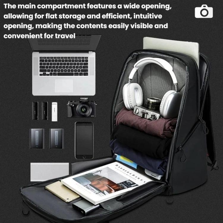 Black camera backpack with wide-opening compartment holding laptop, headphones, and accessories.