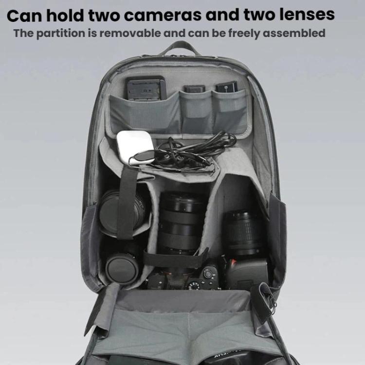 Black camera backpack open with removable partition holding two cameras and lenses.