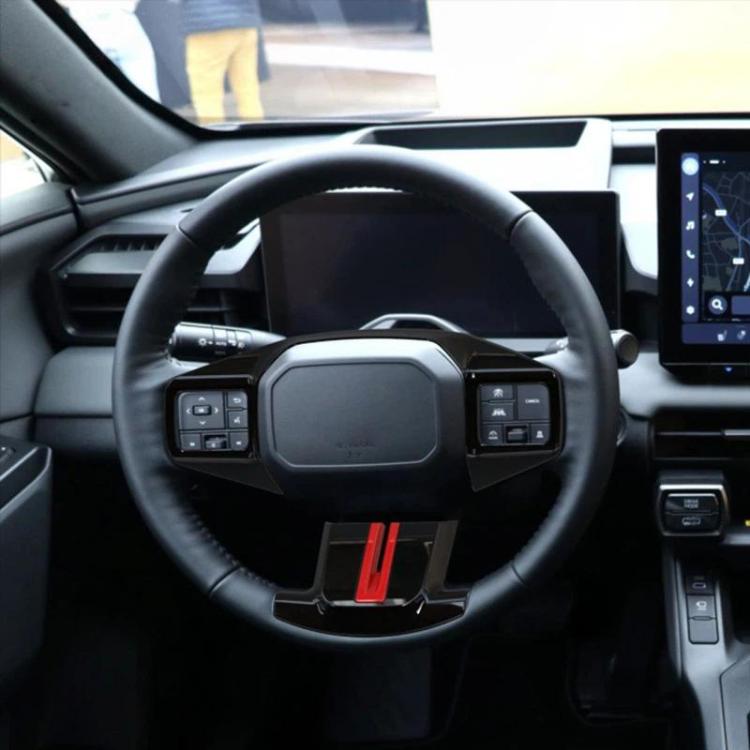 Steering wheel adjustment button trim cover with dark bezel and red accent stripe