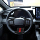 Steering wheel adjustment button trim cover with carbon-fiber pattern and red accent stripe