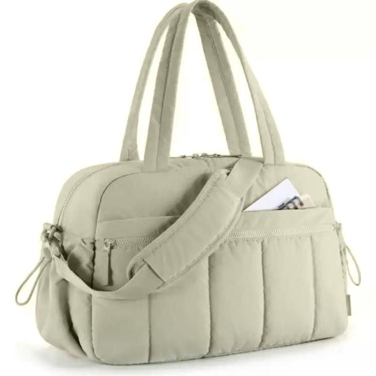 Sage green travel bag with compartments, padded strap, and zippered front pocket