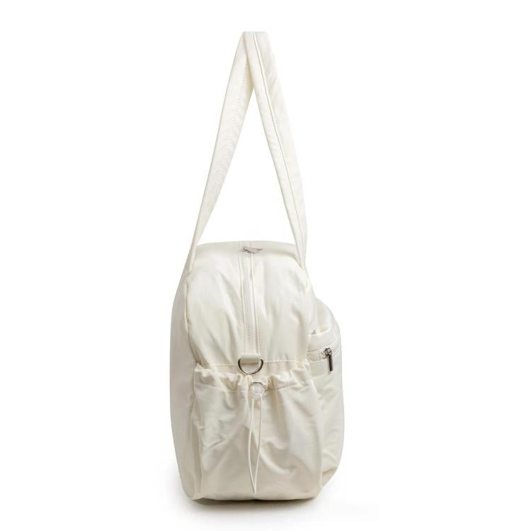 White travel bag with compartments, adjustable shoulder strap, and zip closure