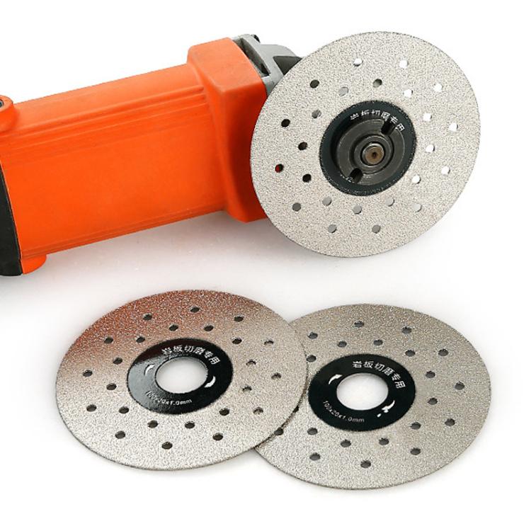 Angle grinder with gray perforated grinding discs and central mounting hub