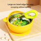 Yellow silicone toddler feeding bowl with 304 stainless steel inner filled with peas.