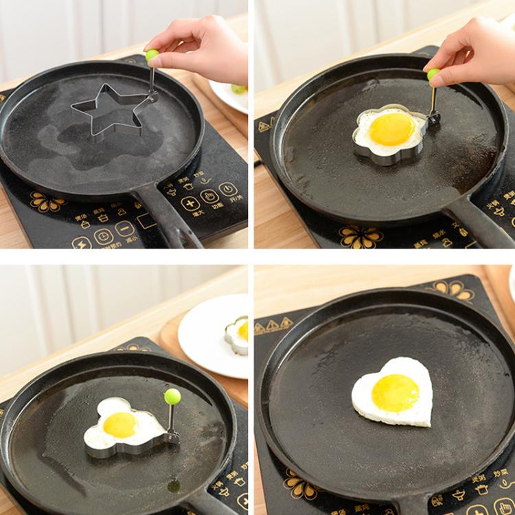 Stainless steel egg mold pressing a sunny-side egg in a frying pan