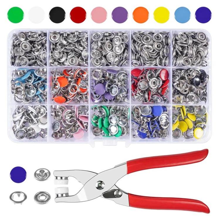 Metal snap fastener set organizer tray with silver snaps and red-handled pliers
