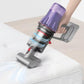 Clear dust bin assembly with red parts attached to cordless vacuum during use