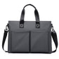 Men's waterproof laptop messenger bag in black with dual front pockets and side carry straps
