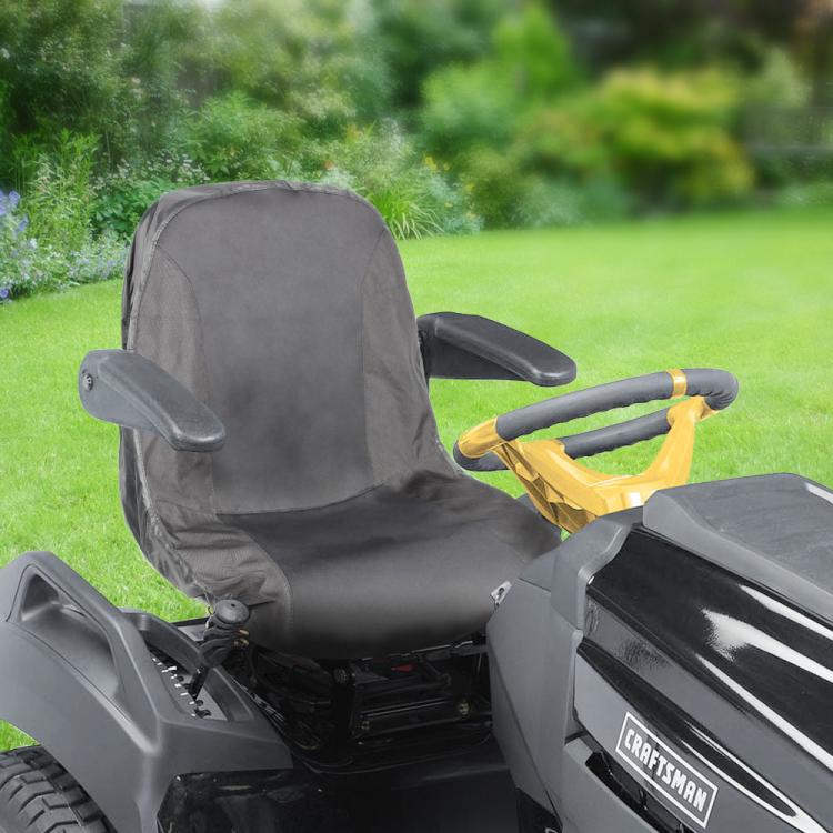 Dark gray tractor seat cover fitted on outdoor lawn mower seat