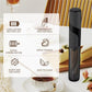 Black handheld electric milk whisker with frothing head, on countertop