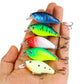 Assorted hard crankbait lures in blue, green, red, and yellow tones with treble hooks