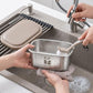 Stainless steel mini container being cleaned by hand with beige lid on sink