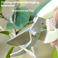 Ivory-handled pruning shears cutting branches, stainless steel blades
