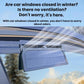 White solar ventilation fan installed above the car windshield