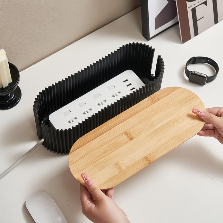 Desktop cable management box showing interior tray with outlet cutouts and wood lid.