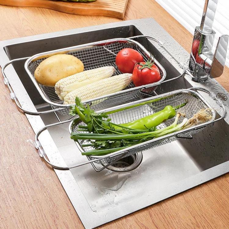 Expandable sink colander strainer set with fine mesh baskets holding vegetables