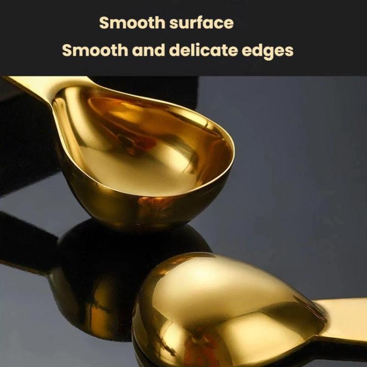 Gold coffee measuring spoon with smooth oval bowl and handle, scale markings on handle