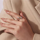 Silver butterfly double-layer ring with green stones on finger