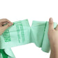 Compostable PLA garbage bags, light green flat bag held open by hands
