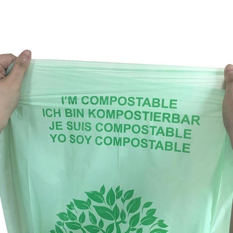 Compostable PLA garbage bag with green text and leaf logo on light green plastic
